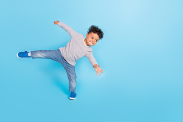Fototapeta na wymiar Full length body size view of attractive cheerful sporty boy dancing break having fun isolated over bright blue color background