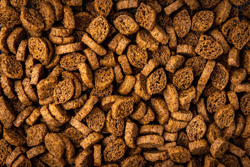 Rye bread crackers on dark wooden background.