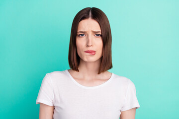 Photo of brunette hair young lady cry bite lip wear white t-shirt isolated on teal color background