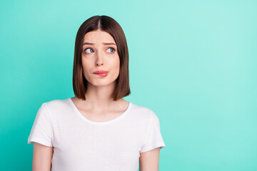 Portrait of attractive worried miserable girl overthinking copy space isolated over bright teal turquoise color background