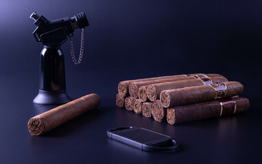 Cigar and lighter, black background