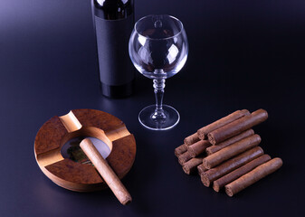 Cigar with wine on black background, Cuban