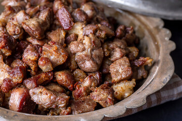 Muslims Traditional Sacrifice holiday food lamb, Turkish roasted meat in copper pot on table top. Turkish Kavurma.