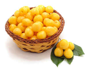 Yellow cherries in a basket.