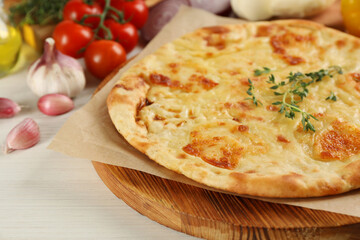 Delicious khachapuri with cheese on white wooden table, closeup