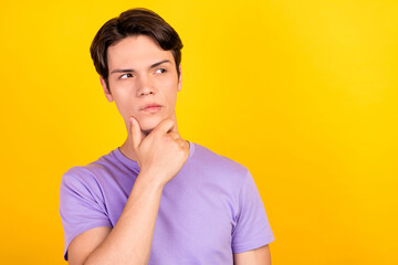 Portrait of attractive suspicious guy overthinking copy blank place space isolated over bright yellow color background
