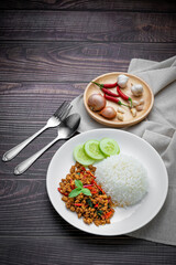 Thai food of spicy thai style fried basil on wooden table., Asian food style.