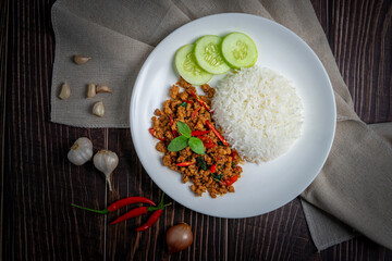 Thai food of spicy thai style fried basil on wooden table., Asian food style.