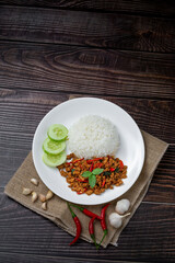 Thai food of spicy thai style fried basil on wooden table., Asian food style.