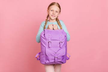 Photo of sweet adorable schoolgirl dressed blue cardigan smiling holding backpack isolated pink color background
