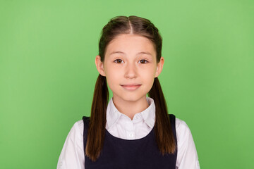 Photo of young school girl happy positive smile confident clever 1-september isolated over green color background