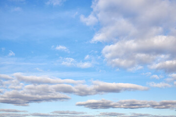Naklejka na ściany i meble Natural daylight and white clouds floating across a blue sky.Blue sky background with clouds