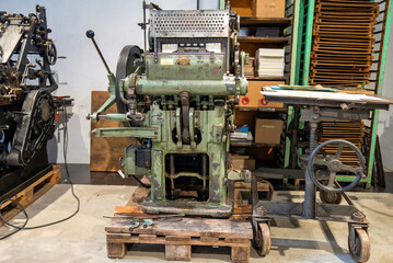 Old typography printing machine with letter samples. Mechanical printing process.