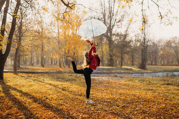 Hello fall, autumn season, fall mood, positive emotions. Teenager girl jumping with transparent...