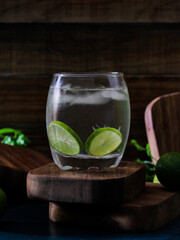 drink with lemon slices on parota wooden cup holders