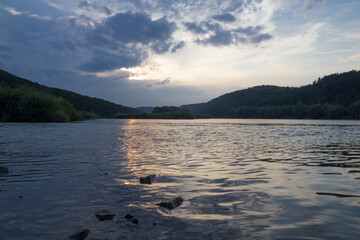 sunset among the clouds on the river