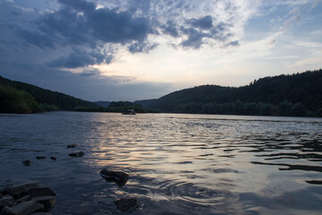 Fototapeta premium sunset among the clouds on the river