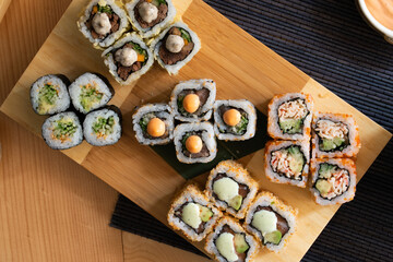 Plate of mixed sushi, top view. Philadelphia, California Roll,
Tempura Roll, Maki.