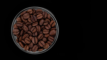 roasted coffee beans on black background, top view