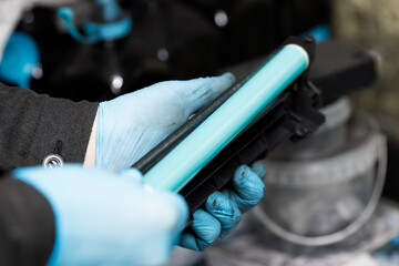 Detail from a laser printer cartridge - shaft.The work of the engineer of the service center for...