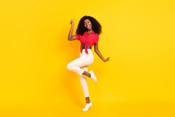 Fototapeta na wymiar Full size profile photo of nice optimistic brunette lady show v-sign wear red top trousers isolated on yellow color backgound