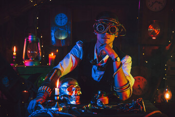 male engineer in cyberpunk glasses and a steampunk suit in a workshop