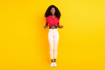 Full size photo of nice impressed brunette lady wear red top trousers isolated on yellow color backgound