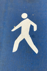 White sign for pedestrian patch on a blue background