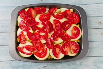 Cooking dinner on a baking tray. Fresh vegetables are chopped and ready to bake in the oven. Home...