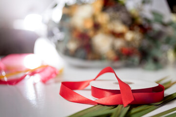 red ribbon on background of the bouquet. shallow depth of field