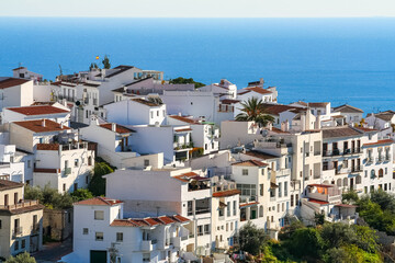 Obraz premium Andalusian white village on a hill and overlooking the blue sea in the background. Frigiliana Malaga.
