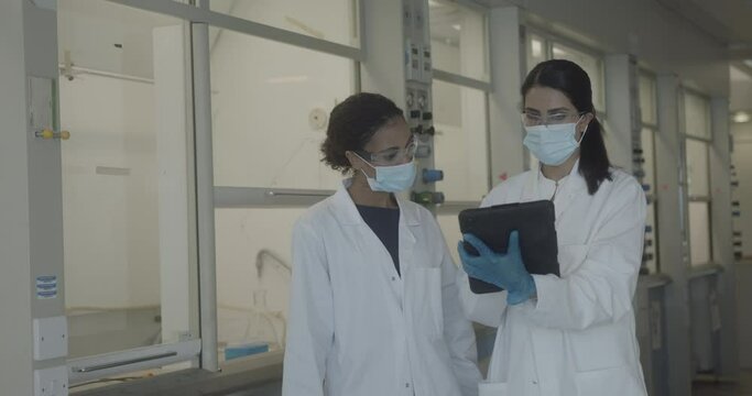Female scientists discussing results of experiment