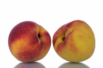 Two ripe peaches, close-up, isolated on white.