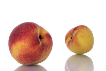 Two ripe peaches, close-up, isolated on white.