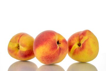 Three ripe peaches, close-up, isolated on white.