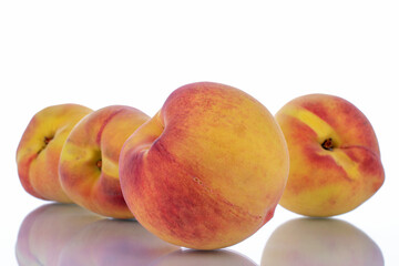 Several ripe peaches, close-up, isolated on white.