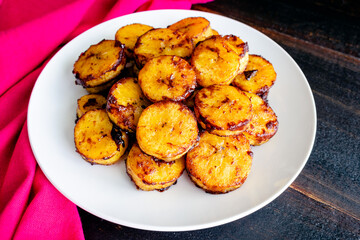 Sweet Caramel Cinnamon Baked Plantains: A plate of baked plantains covered in cinnamon and caramelized sugar