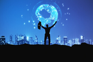Backlit businessman holding glowing earth hologram on dark night city background. Global connection...