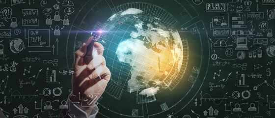 Businessman hand pointing at creative business sketch and globe hologram on chalkboard wall background. Success, seminar and workshop concept.