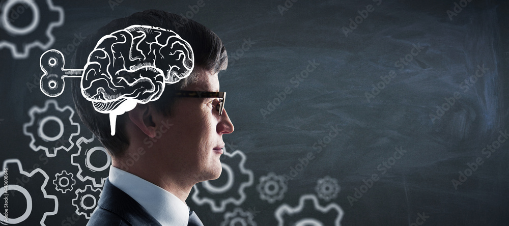 Poster portrait of attractive young european businessman with creative brain and gears sketch on chalkboard