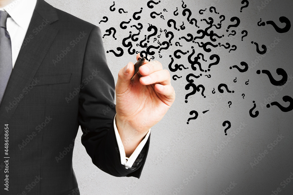 Poster businessman hand drawing abstract question marks on concrete wall background. solution, faq and answ