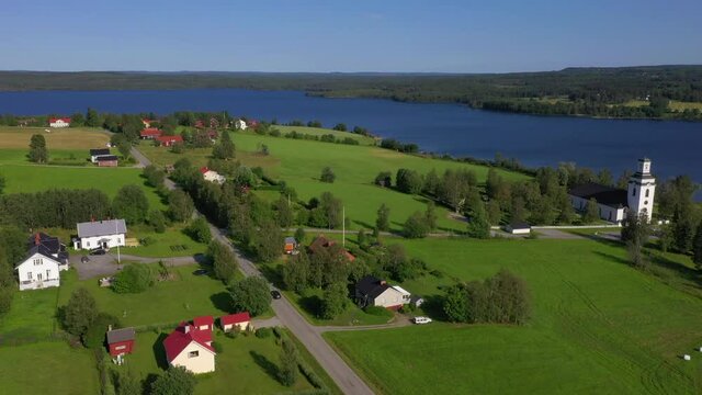 Aerial view of a car driving on a village road in northern Sweden