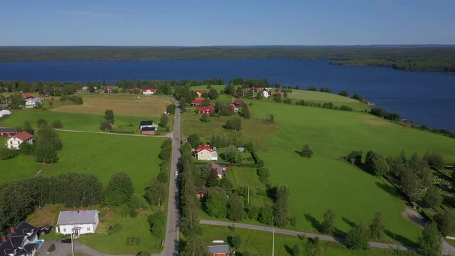 Aerial view of a car driving on a village road in northern Sweden