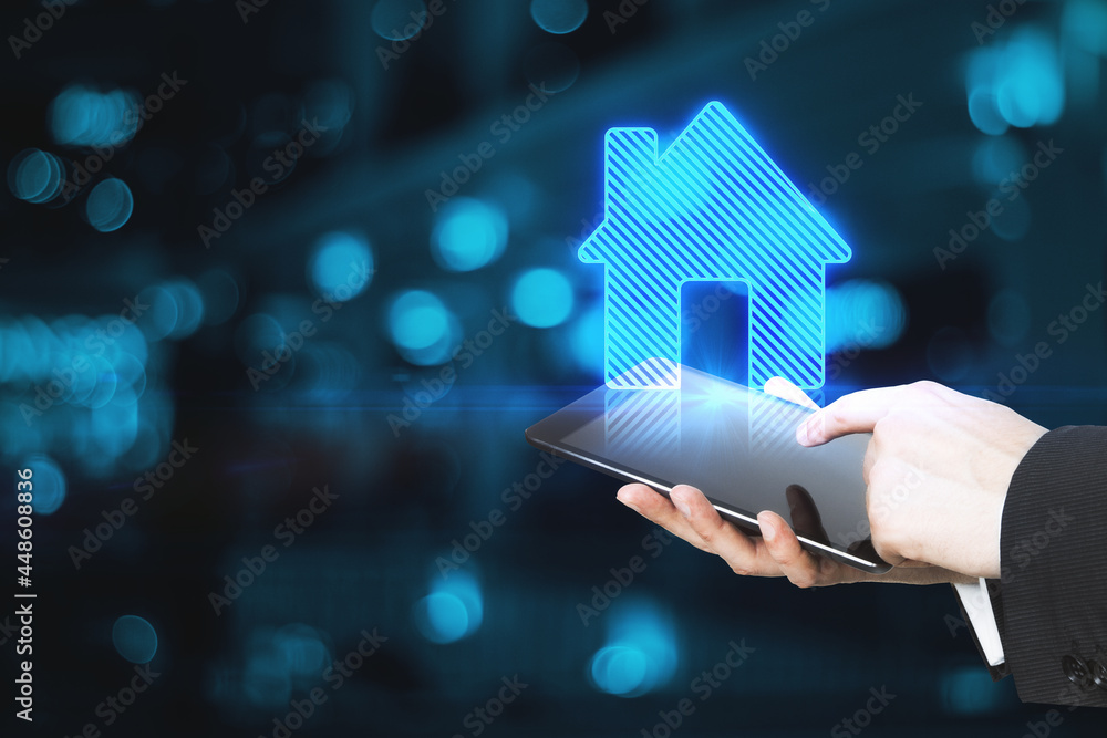 Poster close up of male hands holding tablet with abstract house icon on blue bokeh background with mock up