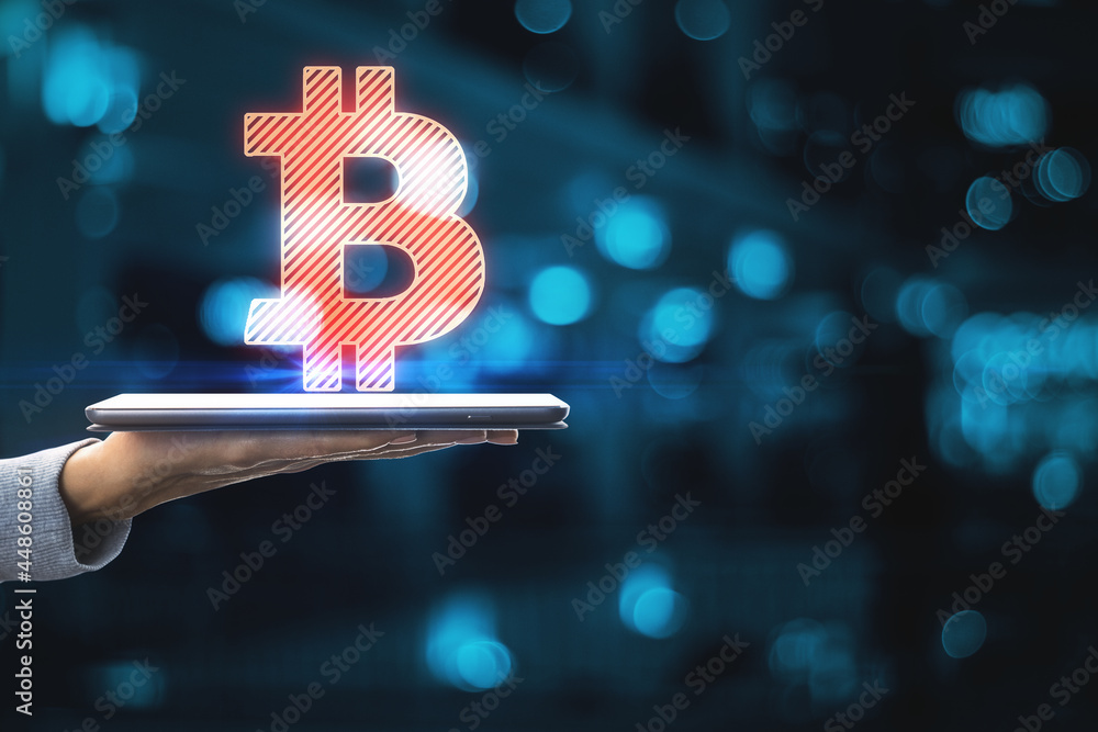 Poster close up of woman hands holding smartphone with abstract glowing bitcoin sign on blue bokeh backgrou