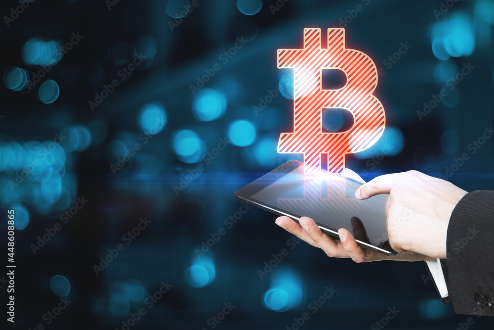 Poster Close up of male hands holding tablet with abstract glowing bitcoin sign on blue bokeh background with mock up place. Cryptocurrency and blockchain concept.