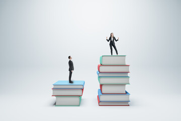 Businessman and woman standing on books on white background. Competition, education and knowledge...