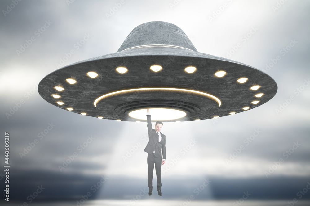 Poster abstract grey ufo taking businessman in dull sky. spaceship, kidnapping and science concept.