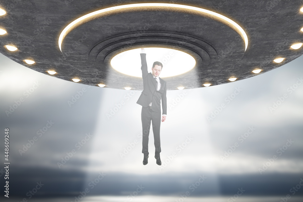 Aufkleber abstract grey ufo taking businessperson in dull sky. spaceship, kidnapping and science concept.