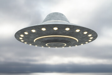 Creative grey UFO flying in blurry dull sky with mockup place. Spaceship and science concept. 3D Rendering.
